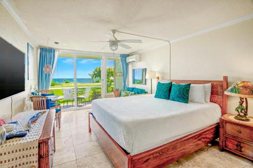 a bedroom with a bed and a view of the ocean at Romantic Oceanfront Escape in Kapaa