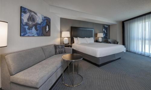 a hotel room with a bed and a couch at Hyatt Regency San Francisco Airport in Burlingame