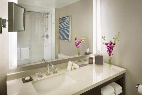 a bathroom with a sink and a large mirror at Hyatt Regency San Francisco Airport in Burlingame