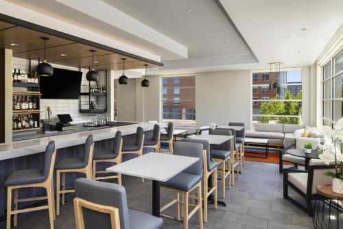 a restaurant with tables and chairs and a bar at Hyatt House Pittsburgh-South Side in Pittsburgh