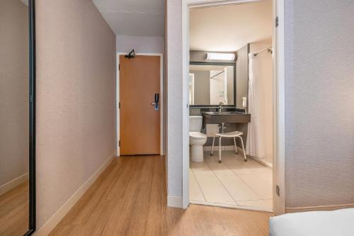 a bathroom with a sink and a toilet in a room at Comfort Inn Montreal - Laval - Highway 15 in Laval