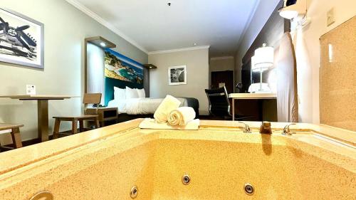 a room with a large tub in a hotel room at Quality Inn & Suites Los Angeles Airport - Stadium District in Inglewood