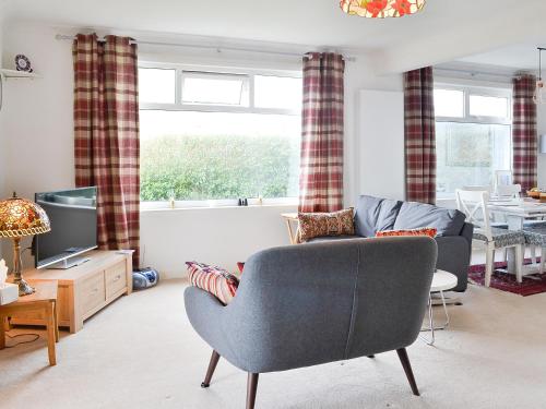 a living room with a couch and a tv at Craignair in Port William