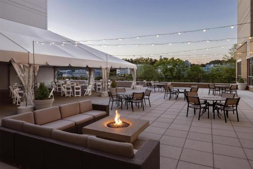 a patio with a couch and tables and chairs at Hyatt House Pittsburgh-South Side in Pittsburgh