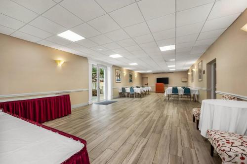 a large room with tables and chairs in it at Comfort Inn Oceanside Deerfield Beach in Deerfield Beach