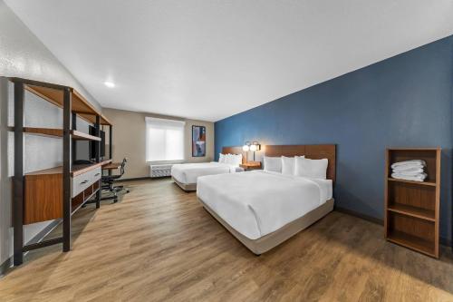 a hotel room with two beds and a tv at Everhome Suites Ontario in Ontario