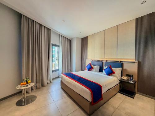 a hotel room with a bed and a window at Zip By Spree Hotels Chinchwad in Chinchwad