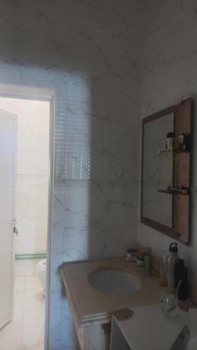 a bathroom with a sink and a mirror and a tub at BRAZIL House in Muscat