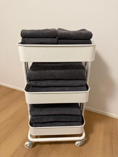 a stack of towels on a towel cart at 蔵 The KURA in Urayasu