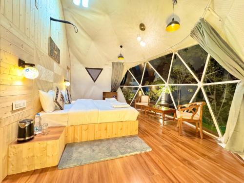 a bedroom with a bed in a tent at Glamo home kasauli in Kasauli