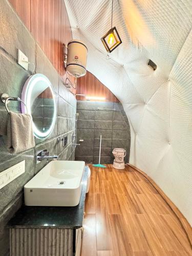 a bathroom with a sink and a mirror at Glamo home kasauli in Kasauli