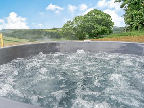 a bath tub filled with water on a road at Gwennol- Uk37573 in Llanboidy
