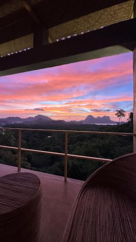 a view of a sunset from the balcony of a house at Vista Cadlao in El Nido