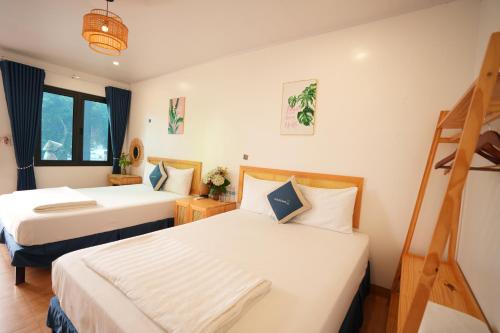 a hotel room with two beds and a ladder at Cat Ba SOL Beach in Cat Ba