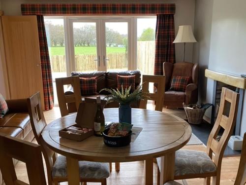 a living room with a table and a couch at Clarinnes Cottage in Rowardennan