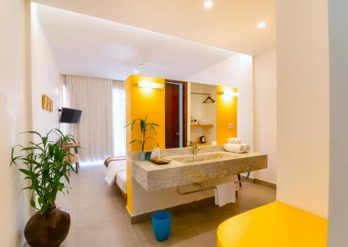 a bathroom with a sink and a bed in a room at Naiya Sea Resort in Sihanoukville