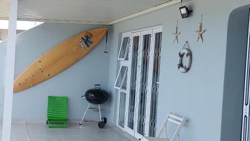 a room with a surfboard hanging on the wall at Nomads Nook 3 in Ramsgate