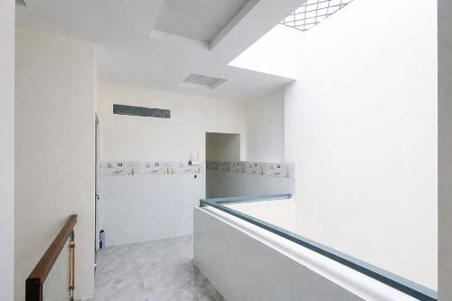 a kitchen with white walls and a skylight at Tâm An Hotel 2 in Nhơn Trạch