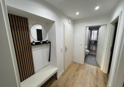 a white bathroom with a mirror and a toilet at CityLoft Wlan Zentral in Essen