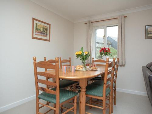 a dining room with a wooden table and chairs at Gull Cottage in Falmouth