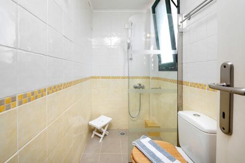 a bathroom with a shower and a toilet at Gouvia bay Serenity in Gouvia