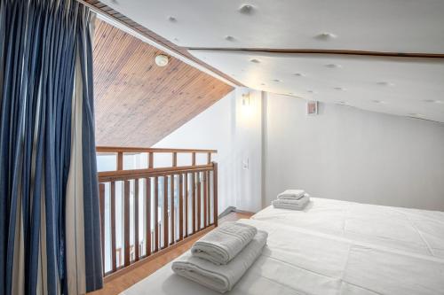 a bedroom with a bed with two towels on it at Gouvia bay Serenity in Gouvia