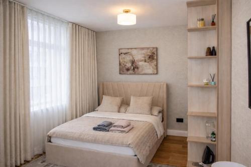 a bedroom with a bed and a window at Central London Apartment in London