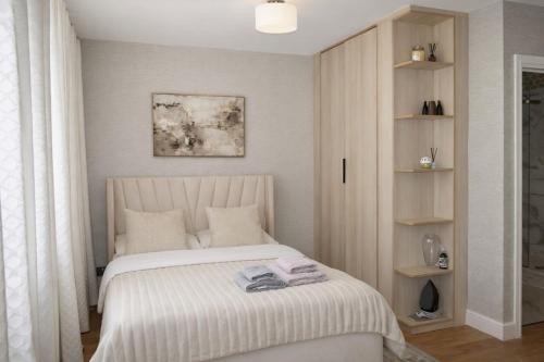 a bedroom with a bed with towels on it at Central London Apartment in London