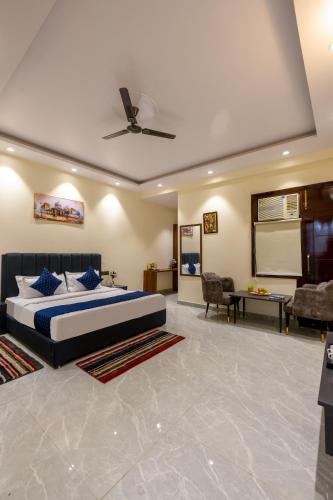 a bedroom with a bed and a living room at Hotel Elite Clark in Noida