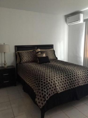a bedroom with a bed in a room with a air conditioner at Beautiful 2 bedroom 1 bath in Tamuning