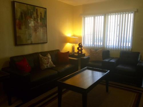 a living room with a couch and a coffee table at Beautiful 2 bedroom 1 bath in Tamuning