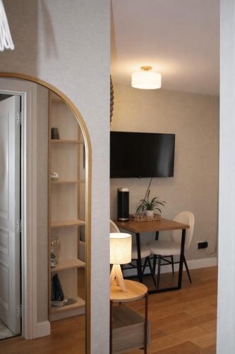 a living room with a table and a tv at Central London Apartment in London
