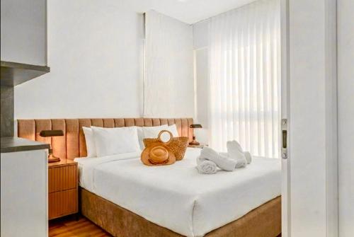 a bedroom with a bed with two stuffed animals on it at Redsearent suite with pool view in Eilat