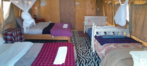 a bedroom with two beds in a room at RetoSafarisMara in Masai Mara