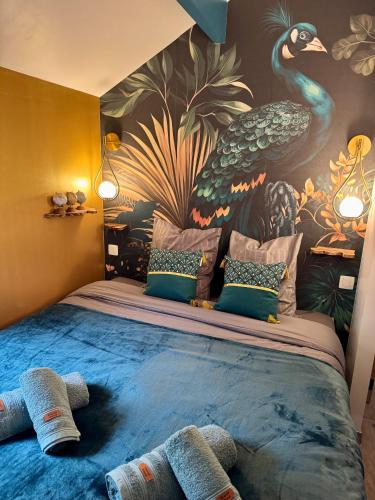 a bedroom with a large bed with a peacock mural at Travel Wood in Waulsort