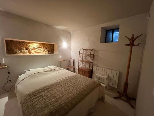 Un dormitorio con una cama y una cruz en la pared. en Chez Serge, en Marsella
