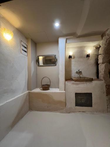 Un baño con lavabo y chimenea. en Chez Serge, en Marsella