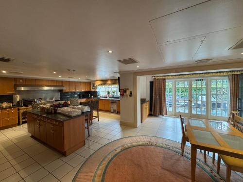 a large kitchen with a table and some chairs at The Bishop in London
