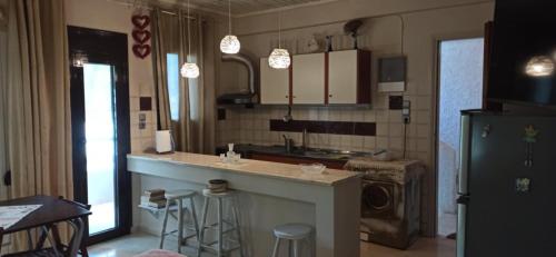 a kitchen with a counter and a sink and a refrigerator at 1st floor studio in Kalathas in Kalathas