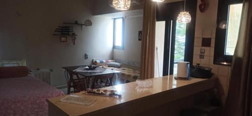 a room with a kitchen and a living room with a table at 1st floor studio in Kalathas in Kalathas