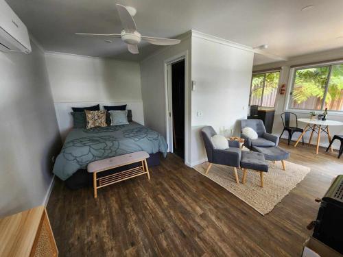 a bedroom with a bed and a living room at Noojee views - cozy studio in Noojee
