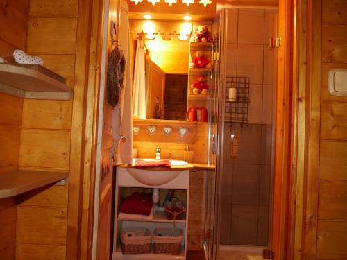 a small bathroom with a sink and a mirror at Chalet la Colombière in Sainte-Agnès