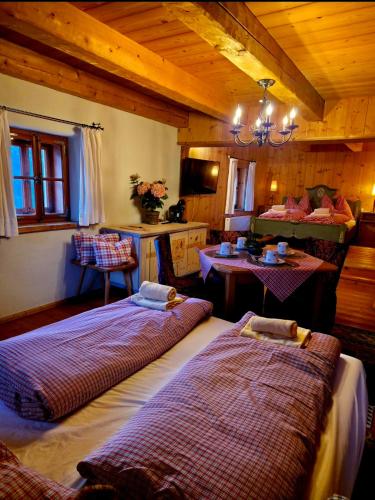a bedroom with two beds and a table in a room at Kanzlei in Abtenau