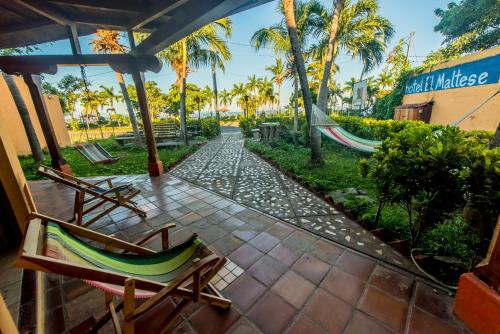 a patio with two chairs and a hammock at Hotel El Maltese in Granada