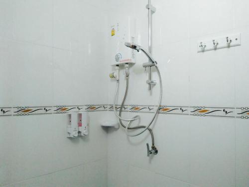 a shower in a bathroom with a shower head at Zam Zam House in Ko Lanta
