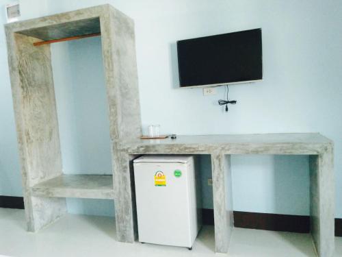 a table with a tv and a refrigerator under a table at Zam Zam House in Ko Lanta