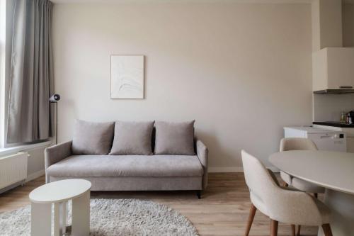 a living room with a couch and a table at Comfortable 1-Bedroom Flat in Central Rotterdam in Rotterdam