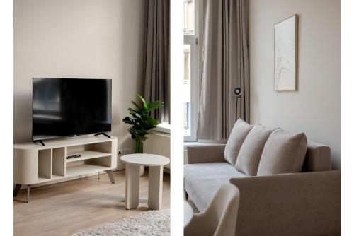 a living room with a couch and a tv at Comfortable 1-Bedroom Flat in Central Rotterdam in Rotterdam