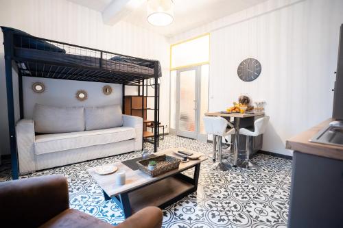 a living room with a bed and a table at Charming studio with sofa, bed and terrace-AS in Carcassonne