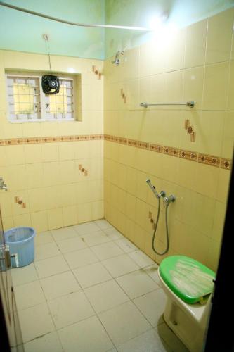 a bathroom with a shower and a toilet in it at Avalan Resort Homestay in Thekkady